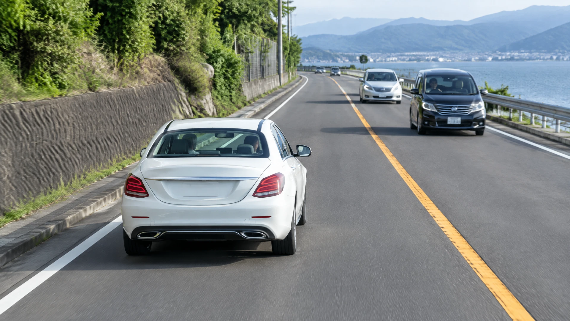 日本の左側車線で車線内の位置を確認する左ハンドルの外車