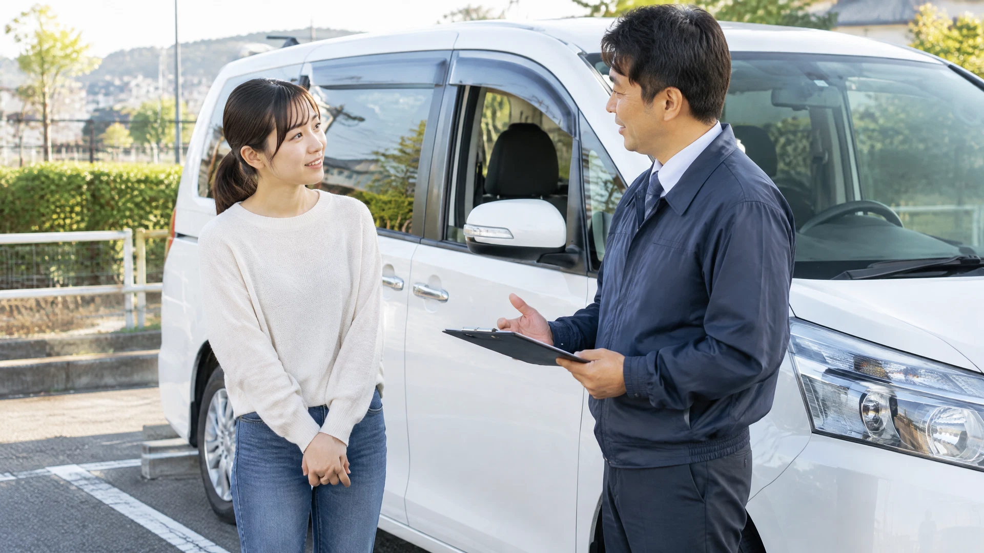 講習後、ミニバンのそばで受講者とインストラクターが振り返りをする様子